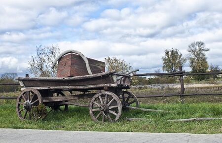 Old wagon on the background of the autumn landscapeの写真素材