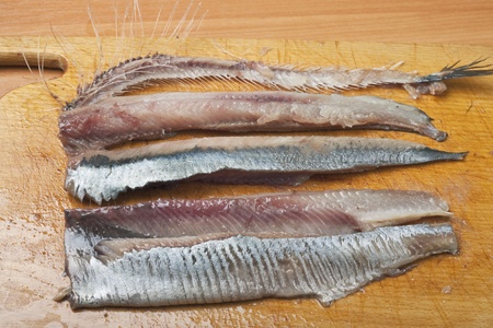 herring fillets on kitchen boardの写真素材