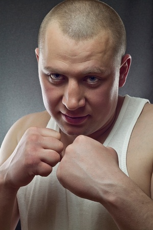 This is a photograph of a young man standing in a boxing positionの写真素材