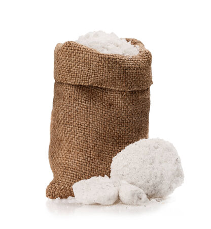 Sea salt in a jute sack on a white background. の写真素材