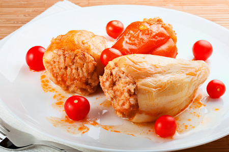 stuffed peppers on a plate isolated on whiteの写真素材