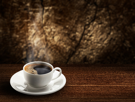warm cup of coffee on brown wood background の写真素材