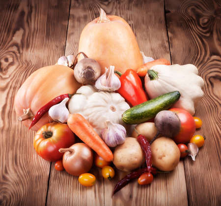 Fresh ripe crop of vegetables on wooden boardの写真素材