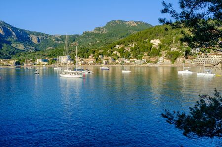 Boats moored in the evening sun in the harbour at Port De Soller Majorca, Spainの写真素材