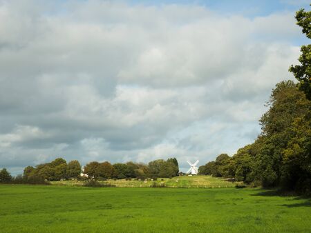 A windmill near the South Downs National Park set against a cloudy sky on an Autumn day
