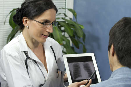 Female Doctor showing patient s xray, horizontal