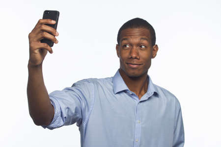 Young African-American man taking a picture of himself with smartphone, horizontal 