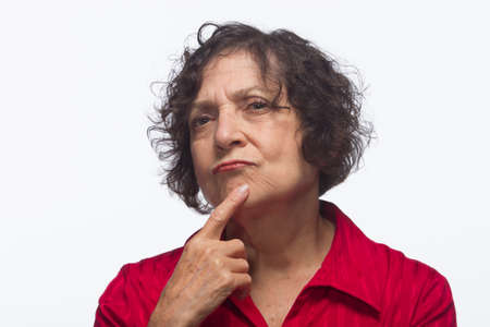 Woman thinking with hand to face, horizontalの写真素材