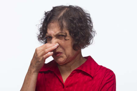 Woman plugs nose, horizontalの写真素材