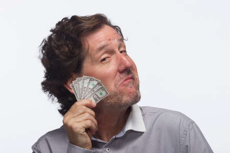 Smug man with money, horizontalの写真素材