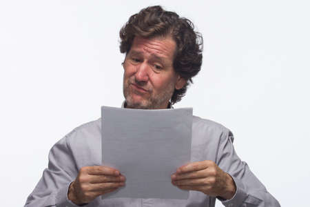 Skeptical business man with reports, horizontalの写真素材