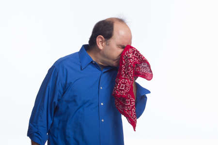 Man sneezing into handkerchief, horizontal の写真素材