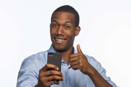 Young African American man taking picture with smartphone