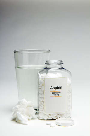 Glass of water and aspirin bottleの写真素材