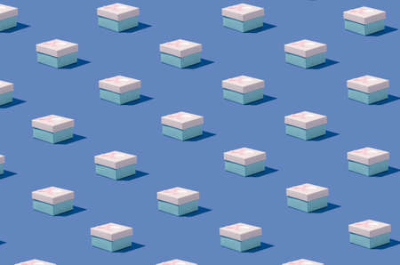 Creative isometric pattern made of gift boxes on pastel blue background. Minimal concept. Wallpaper, banner.の写真素材