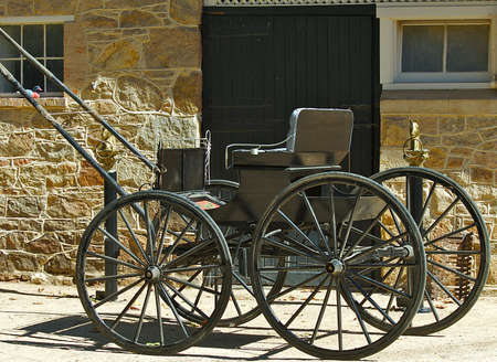Old style buggy in front of an old barn.の写真素材