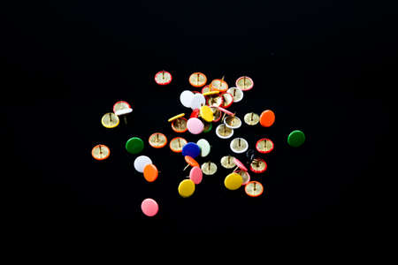 multicolored  isolated pins on black tableの写真素材