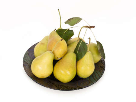 fresh pears on plate with foliageの写真素材