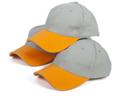 three cool gray baseball caps with orange visorの写真素材