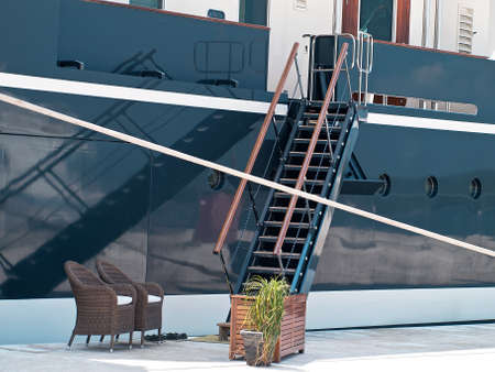 modern yacht moored in the port, gangway and reflectionの写真素材