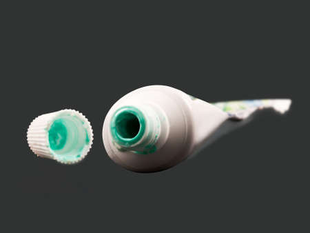 empty toothpaste on gray backgroundの写真素材