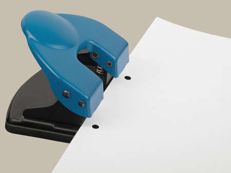 drilling hole punch with paper, studio shotの写真素材