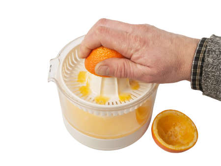preparing orange juice squeezing oranges, studio shot
