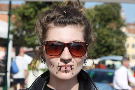 ROVINJ, CROATIA - SEPTEMBER 14: Unidentified girl with a lot of piercing on the street of Rovinj during the Unknown Festival on September 14, 2013. The annual Unknown Festival is from September 10 to September 14, 2013.のeditorial素材