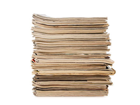 a pile of old yellow magazines isolated on white background, studio shot