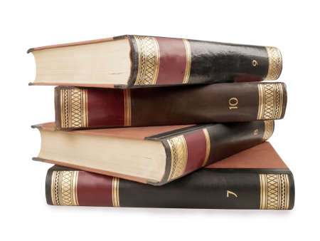 four heavy book tomes isolated, studio shotの写真素材