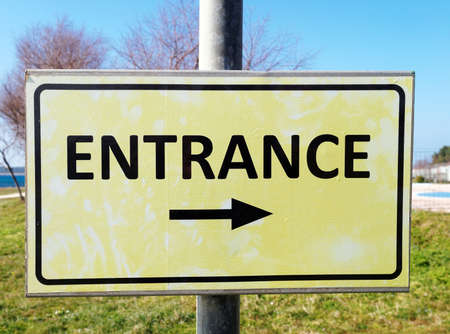 entrance sign with black arrowの写真素材