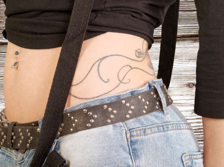 girl in jeans with navel piercingの写真素材