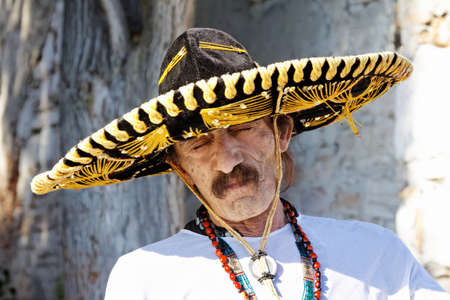 mexican man with sombrero posing outdoorの写真素材