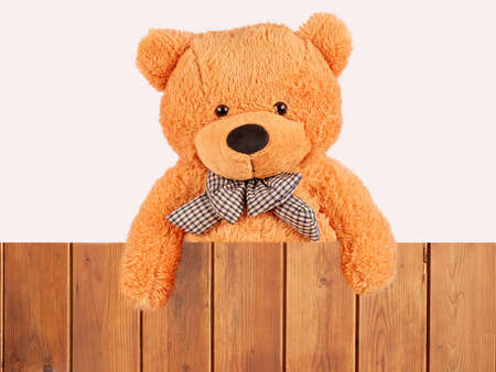 fluffy plush teddy bear over wooden fence, studio shotの写真素材