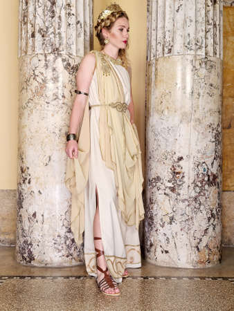 woman in traditional roman clothing posing in templeの写真素材