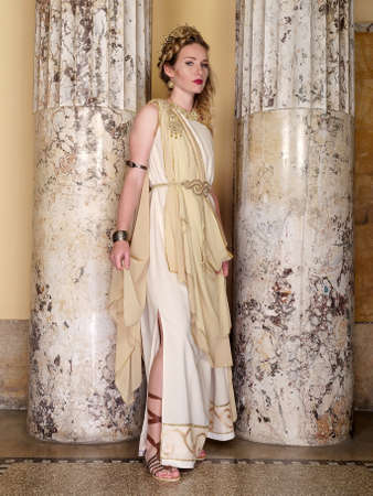 woman in traditional roman clothing posing in templeの写真素材