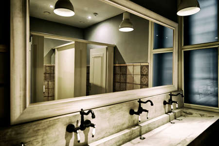 modern public toilet with washbasin under lightsの写真素材