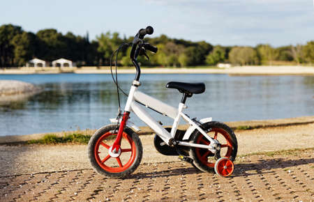 children's bike standing on the promenade near the sea