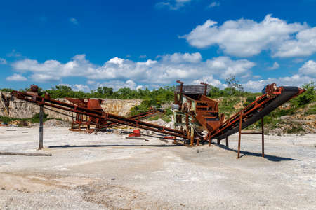 Old rusty stone crushing machines in abandoned quarryの写真素材