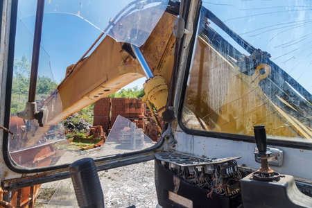 old yellow cracked cabin of abandoned excavatorの写真素材