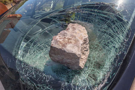 broken car windshield with a huge stoneの写真素材