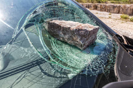 broken car windshield with a huge stoneの写真素材