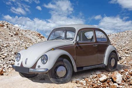PULA, CROATIA - JUNE 25, 2015: VW beetle old-timer car parked at stone narrow passage in Pula,...