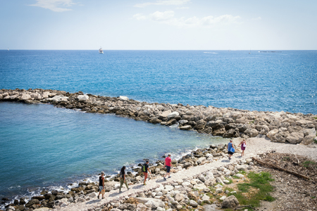 People walking along the beach in Cannes, Cote d'Azurの写真素材