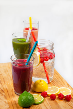 A serving platter with four drinks and smoothies lined up using food-grade, silicone straws that are reusable, and a plastic alternative to be sustainableの写真素材