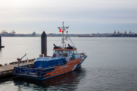 North Vancouver, British-Columbia / Canada - 11/14/2020: The Harbor Sentinel Oil Response boat sits at a dock in Lonsdale Quay, in Vancouver harbor, ready to respond to a spill from nearby freightersのeditorial素材
