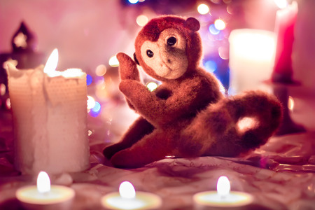 felted toy monkey and candles. Christmas. Symbol in 2016.の写真素材