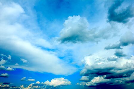 Vibrant storm clouds over the dark blue sky.の写真素材