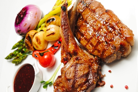 Various types meat roasted with vegetable closeup Beef roasted potato and vegetables Lamb chops with garnish carved roast beef and vegetables grilled ribs shish kebab mixの写真素材