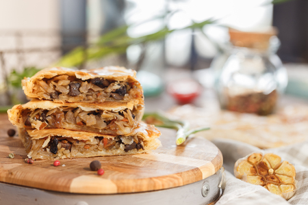 Pie with stewed cabbage and mushrooms Puff pastry cake.の写真素材